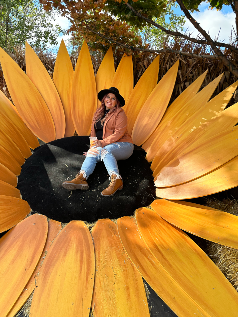 Cassie sitting on a giant sun flower